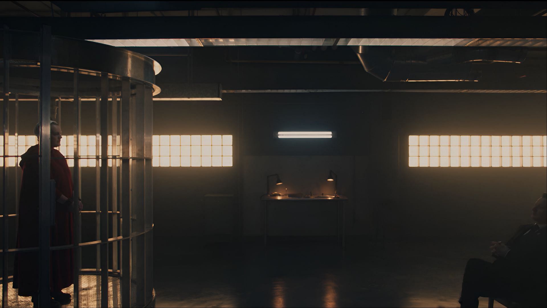 June is held in a high-security Gileadean cell while Commander Wharton delivers a chilling sermon in The Handmaid's Tale season 6 episode 9 (Image via Hulu)